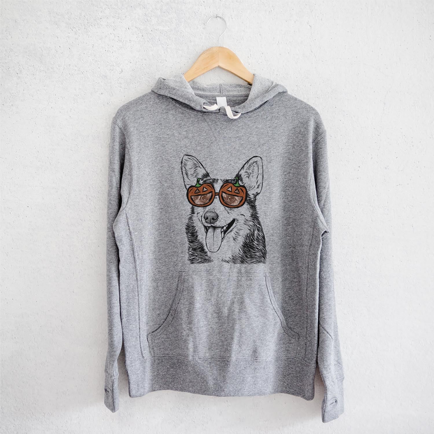 Hand-drawn sketch of Darma the Corgi wearing pumpkin glasses on a Grey pumpkin collection, on a hanger