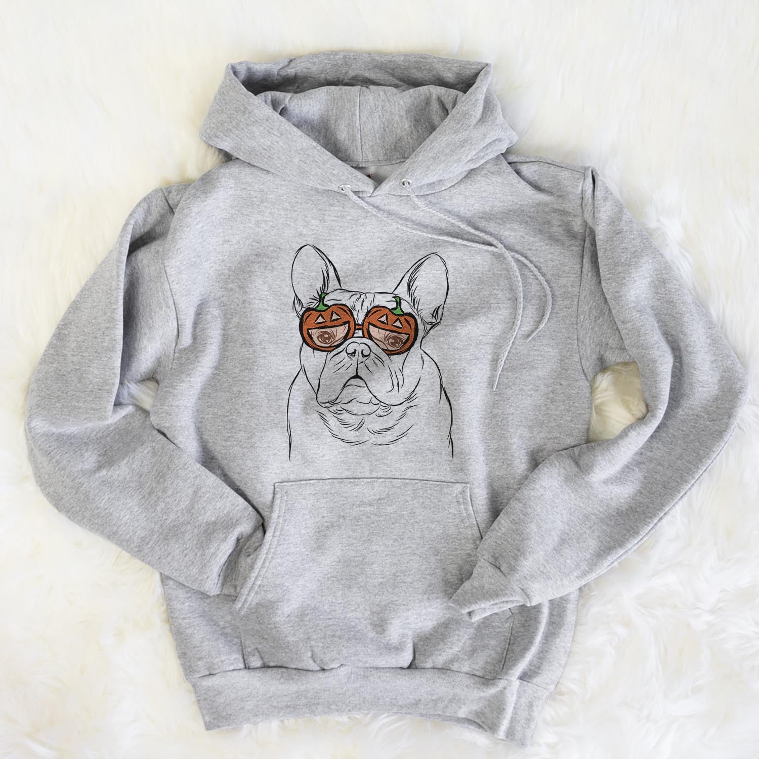 Hand-drawn sketch of Fudge the French Bulldog wearing pumpkin glasses on a Grey pumpkin collection, flat lay