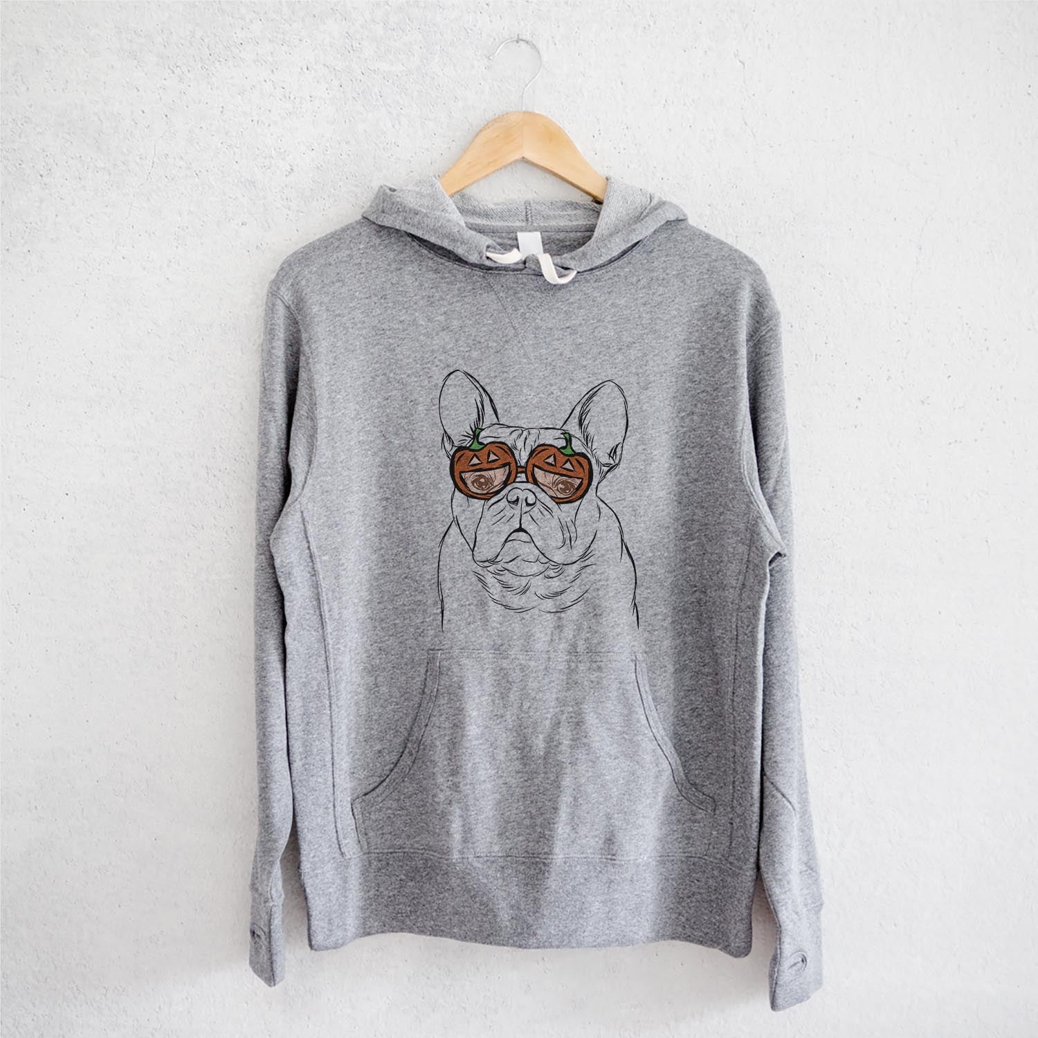 Hand-drawn sketch of Fudge the French Bulldog wearing pumpkin glasses on a Grey pumpkin collection, on a hanger