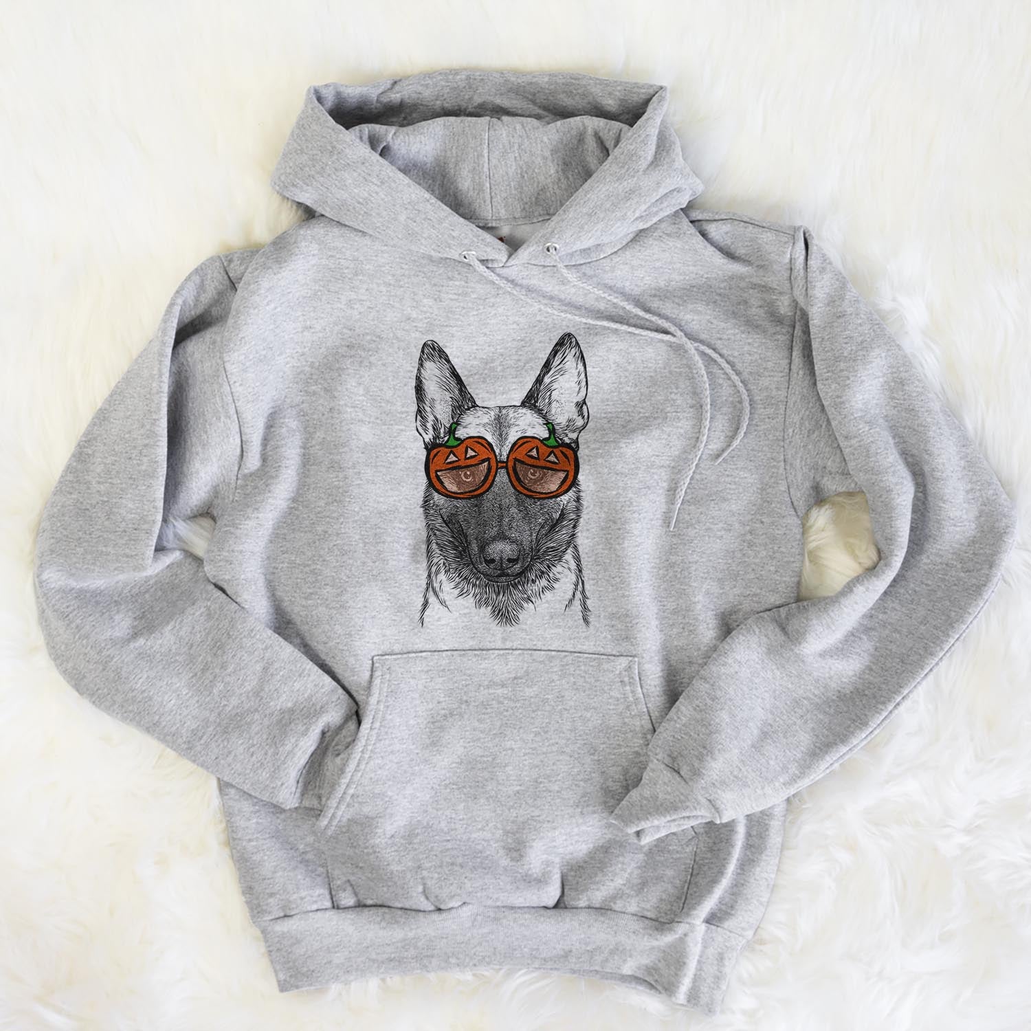 Hand-drawn sketch of Gunther the Belgian Malinois wearing pumpkin glasses on a Grey pumpkin collection, flat lay