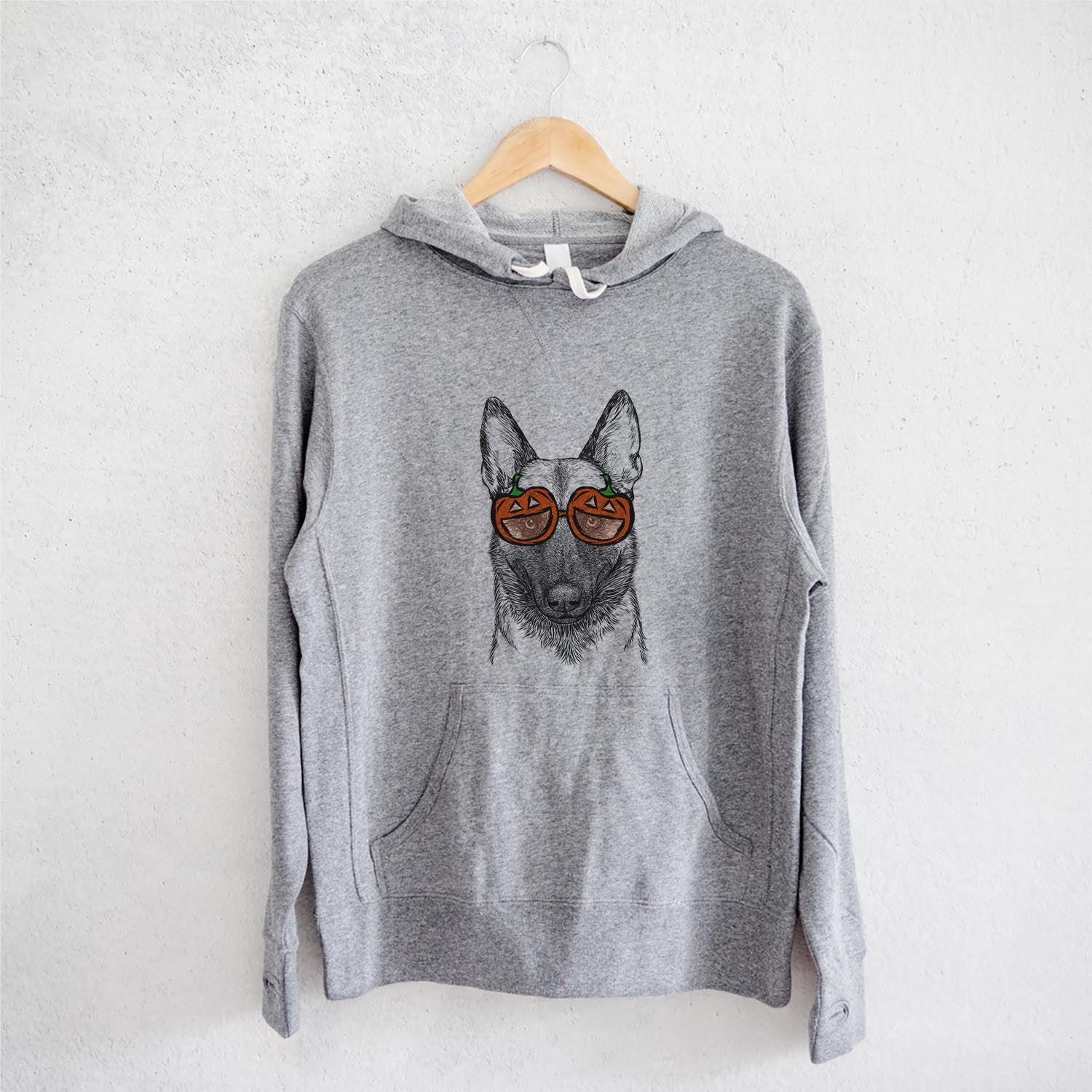 Hand-drawn sketch of Gunther the Belgian Malinois wearing pumpkin glasses on a Grey pumpkin collection, on a hanger