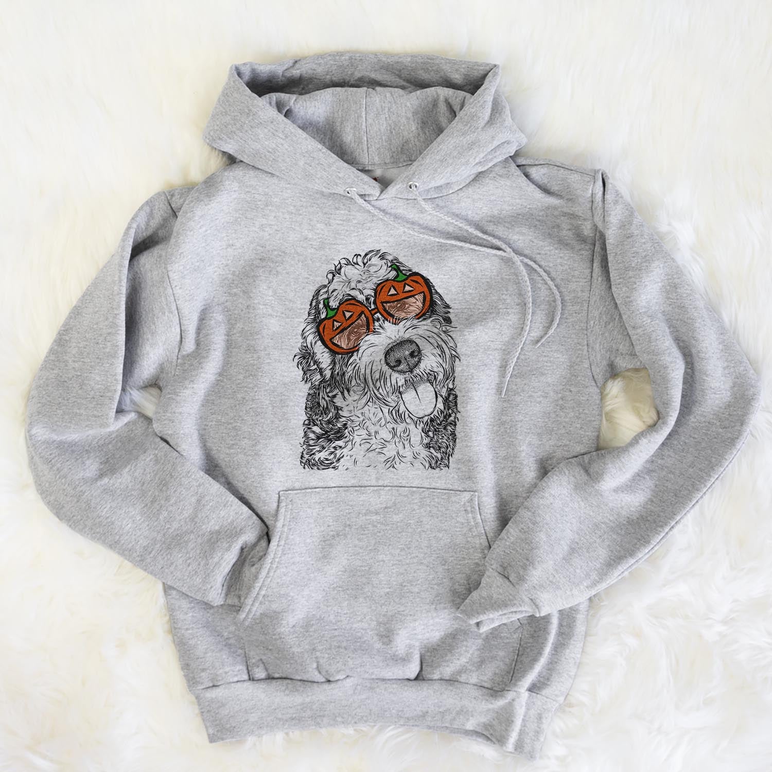 Hand-drawn sketch of Kaci the Bernedoodle wearing pumpkin glasses on a Grey pumpkin collection, flat lay
