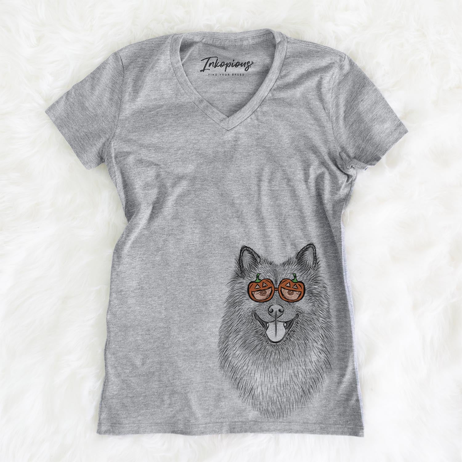 Hand-drawn sketch of Kai the Keeshond wearing pumpkin glasses on a Grey pumpkin collection, on a hanger