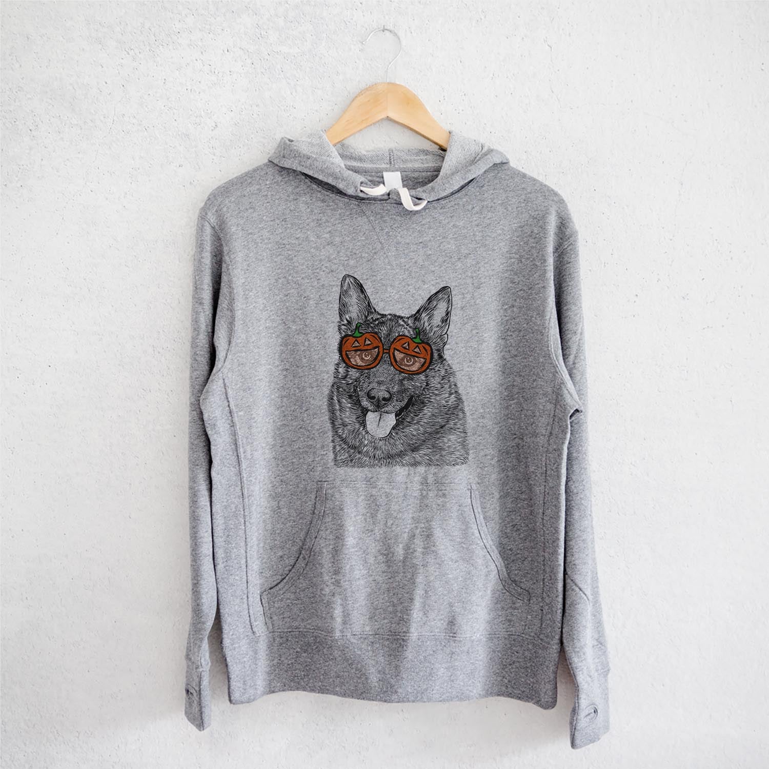 Hand-drawn sketch of Kasia the Norwegian Elkhound wearing pumpkin glasses on a Grey pumpkin collection, on a hanger
