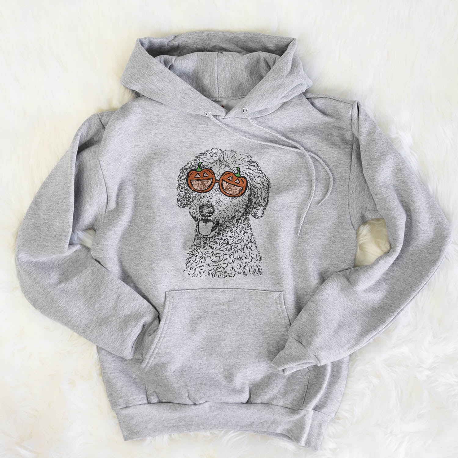 Hand-drawn sketch of Marlow the Goldendoodle wearing pumpkin glasses on a Marlow Doodle pumpkin collection, flat lay