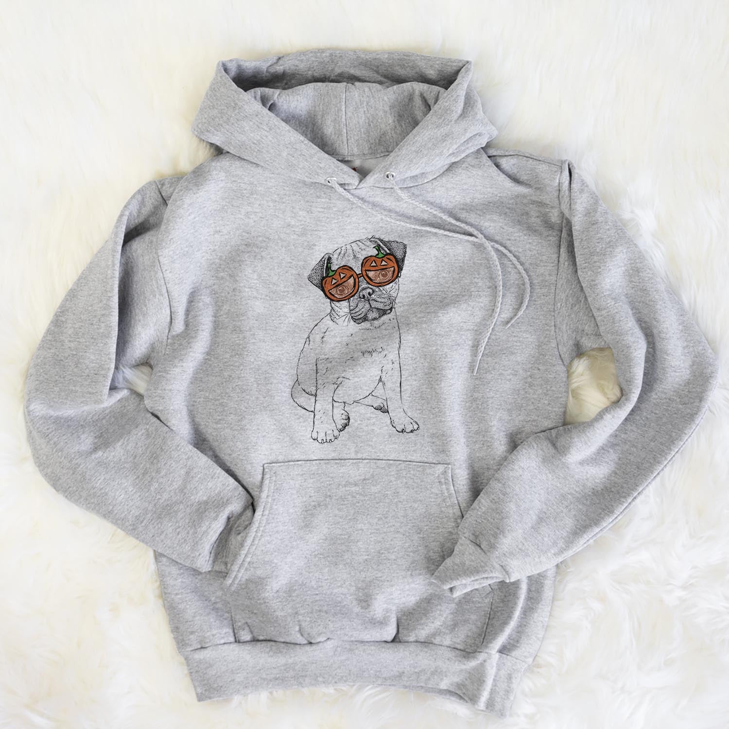 Hand-drawn sketch of Nelson the Pug wearing pumpkin glasses on a Grey pumpkin collection, flat lay
