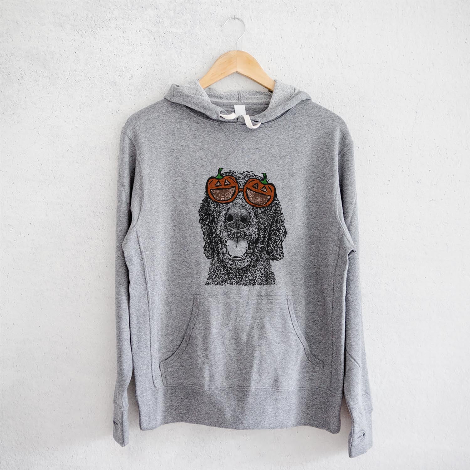 Hand-drawn sketch of Obi James the Goldendoodle wearing pumpkin glasses on a Grey pumpkin collection, on a hanger