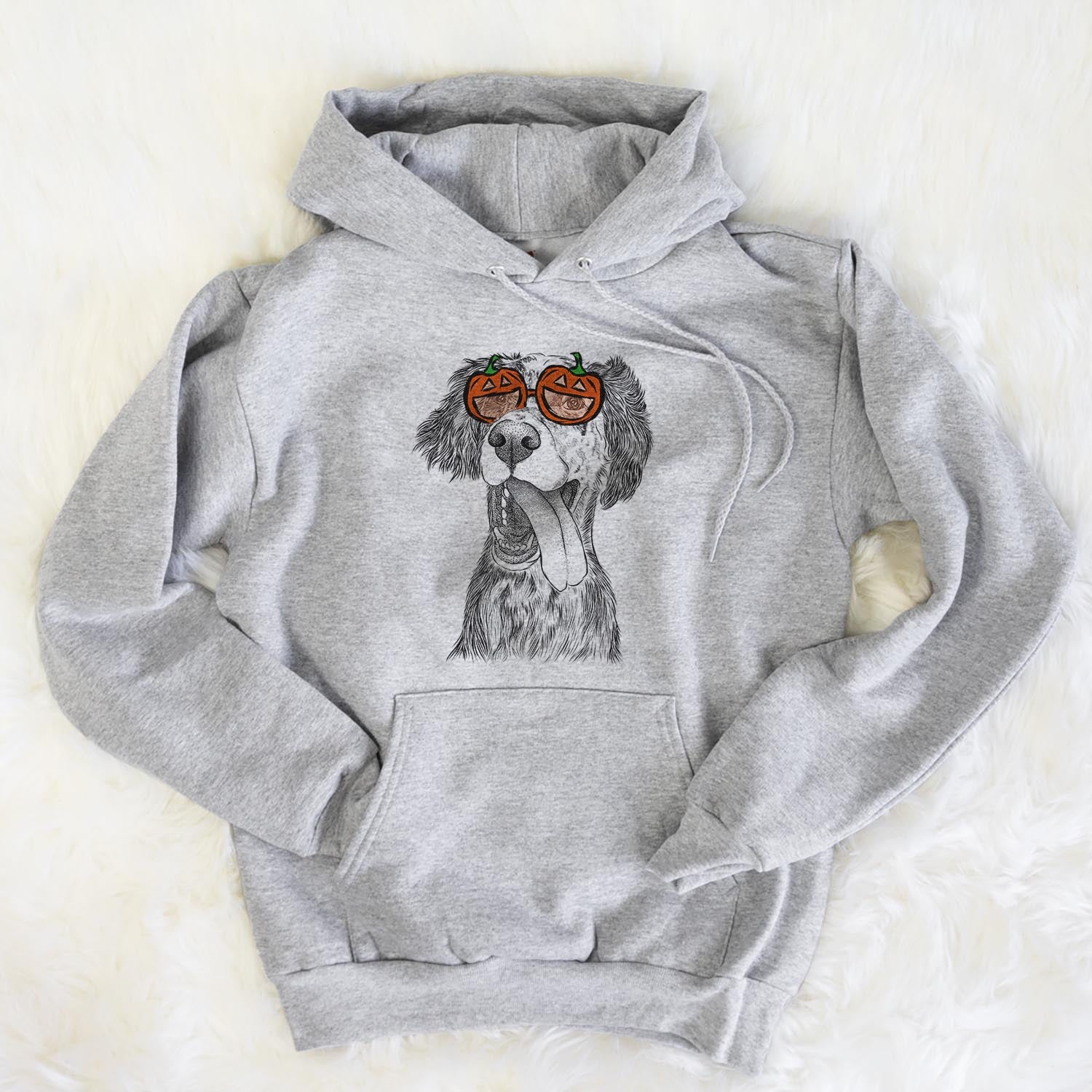 Hand-drawn sketch of Renly the English Setter wearing pumpkin glasses on a Grey pumpkin collection, flat lay