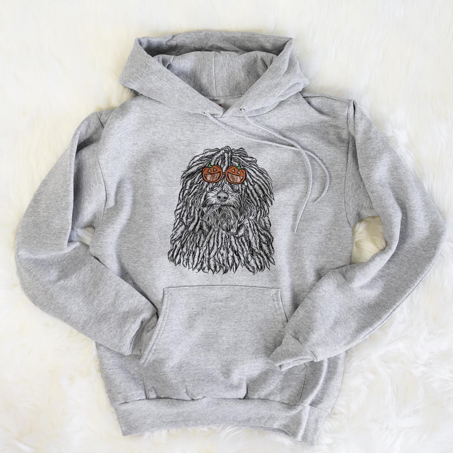 Hand-drawn sketch of Rezi the Puli wearing pumpkin glasses on a Grey pumpkin collection, flat lay