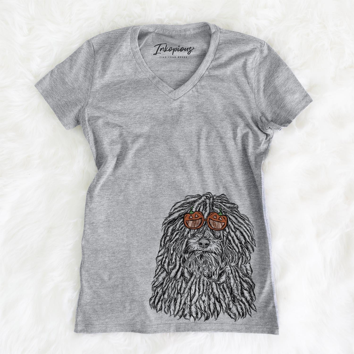 Hand-drawn sketch of Rezi the Puli wearing pumpkin glasses on a Grey pumpkin collection, on a hanger