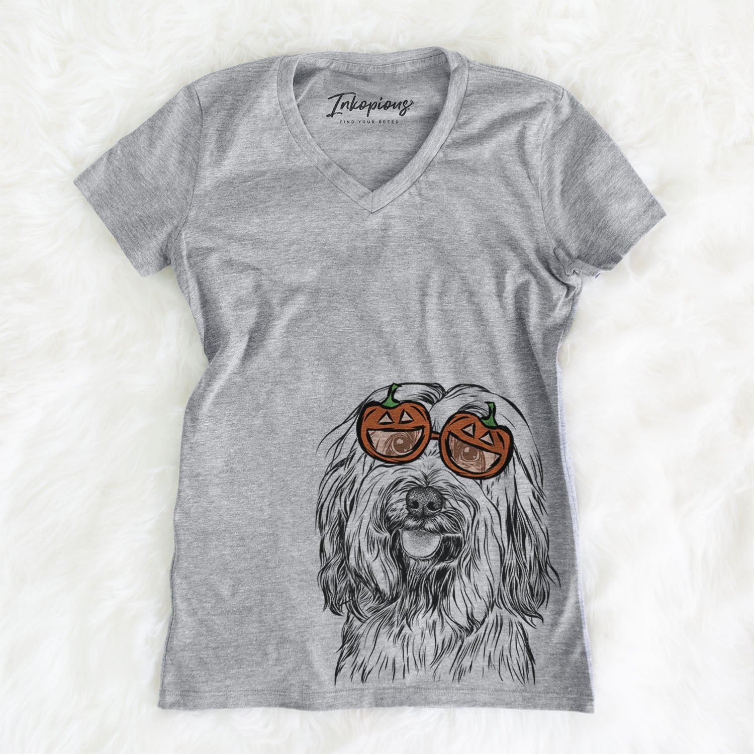 Hand-drawn sketch of Rime the Tibetan Terrier wearing pumpkin glasses on a Grey pumpkin collection, on a hanger