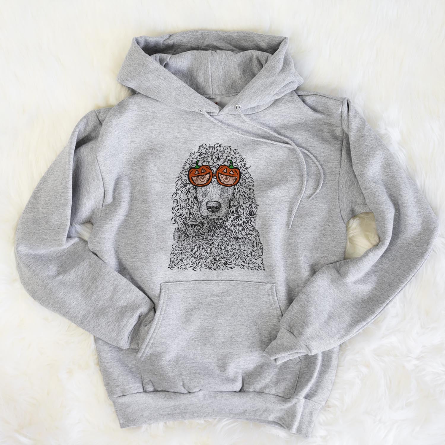 Hand-drawn sketch of Shilo the Irish Water Spaniel wearing pumpkin glasses on a Grey pumpkin collection, flat lay