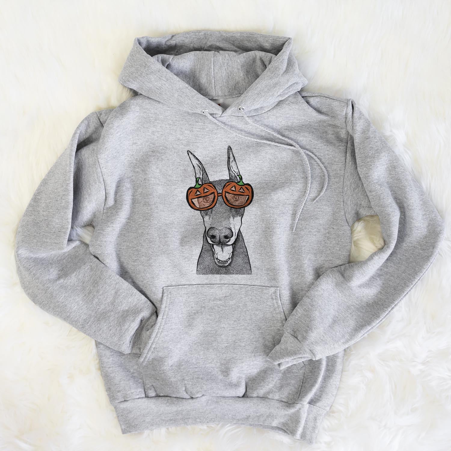 Hand-drawn sketch of Sir Duke the Doberman Pinscher wearing pumpkin glasses on a Grey pumpkin collection, flat lay