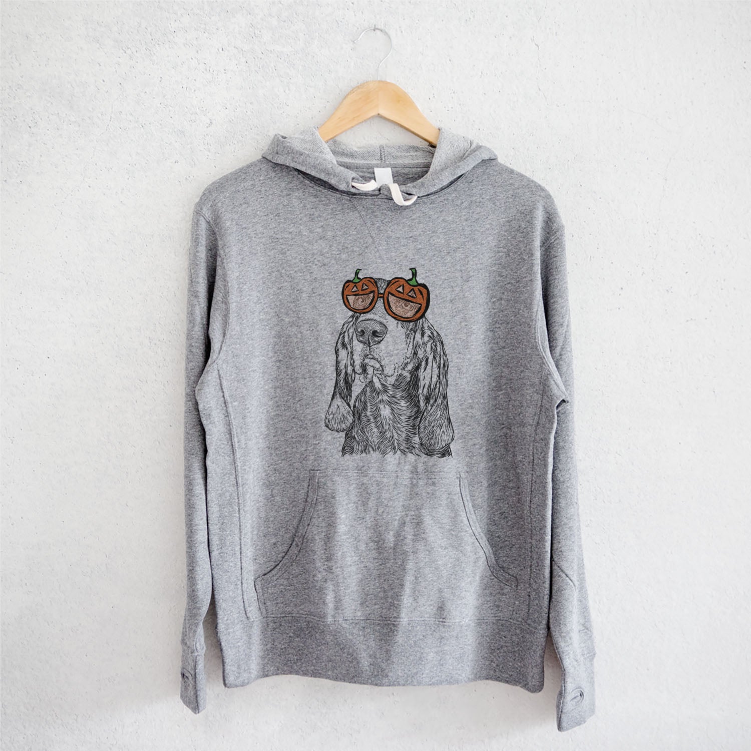 Hand-drawn sketch of Stu the Black and Tan Coonhound wearing pumpkin glasses on a Grey pumpkin collection, on a hanger