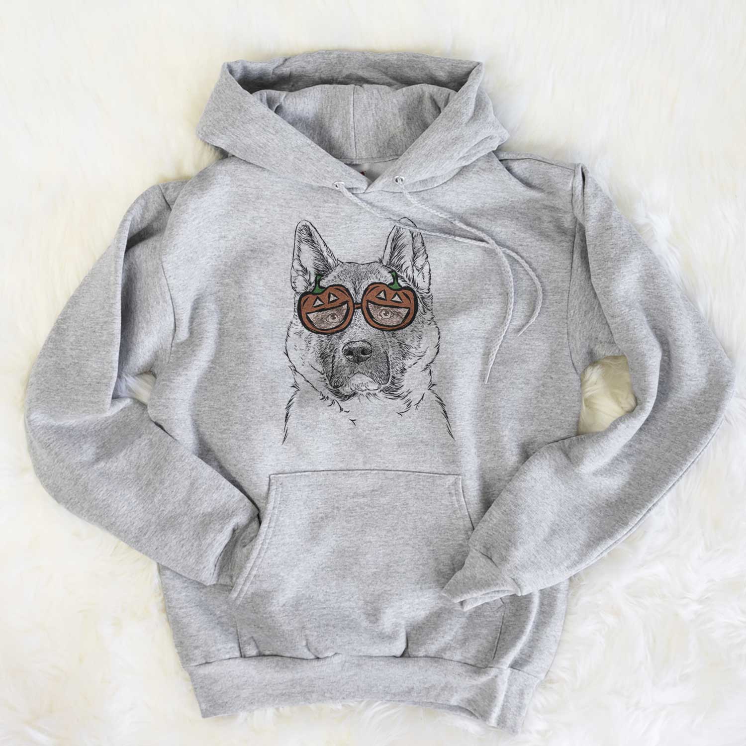 Hand-drawn sketch of Bo the American Akita wearing pumpkin glasses on a Grey pumpkin collection, flat lay