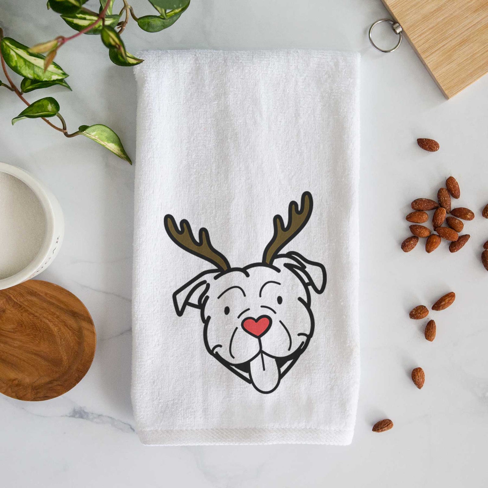 Minimalist line drawing of an American Bulldog with reindeer antlers and a red nose on a decorative hand towel