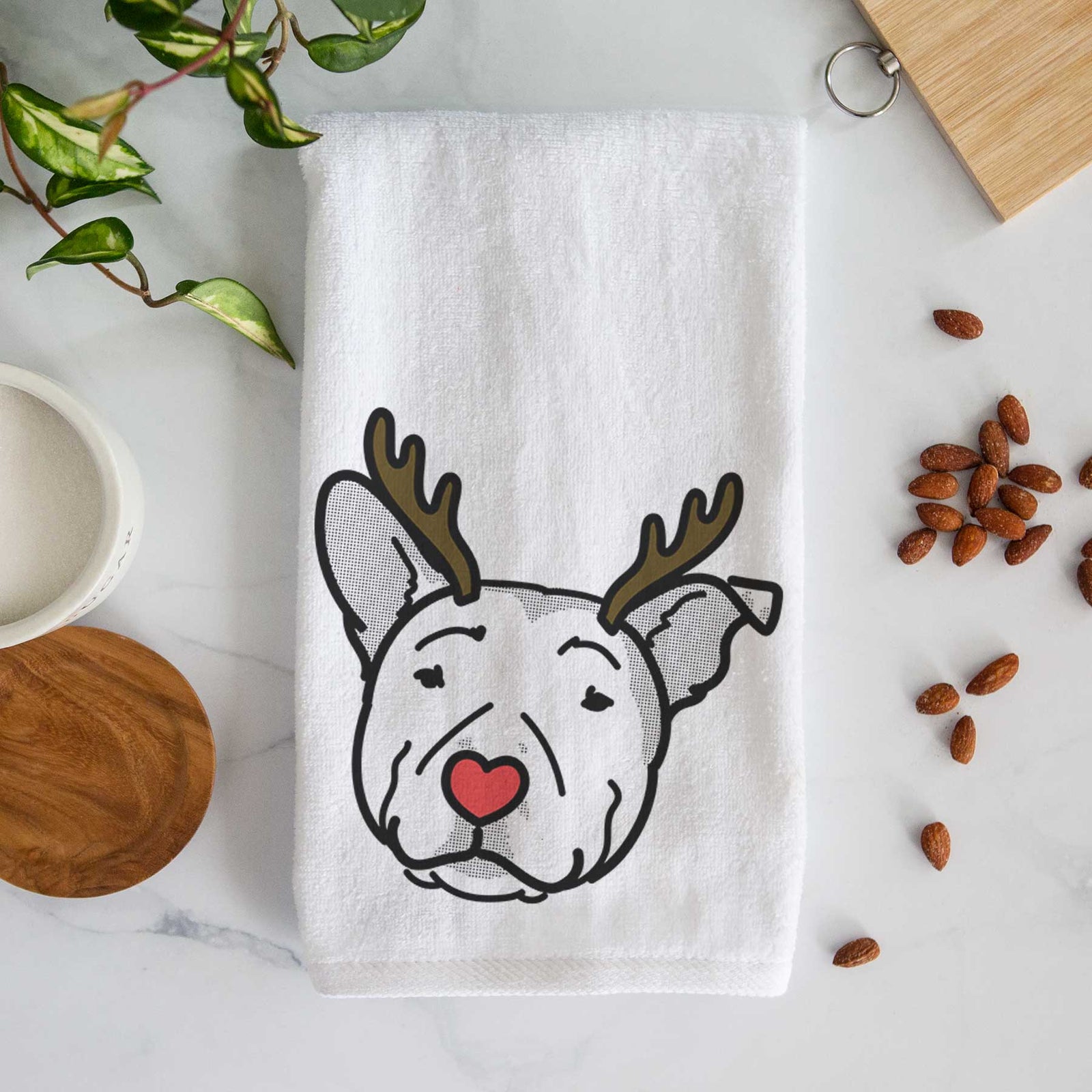 Minimalist line drawing of Archer the Pitbull with reindeer antlers and a red nose on a decorative hand towel