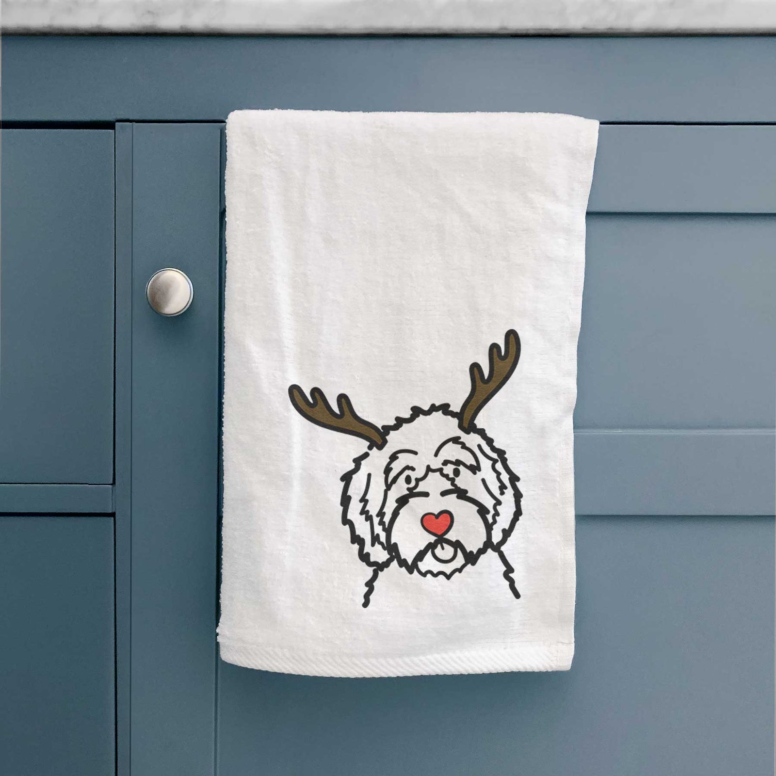 Minimalist line drawing of an Aussiedoodle with reindeer antlers and a red nose on a decorative hand towel
