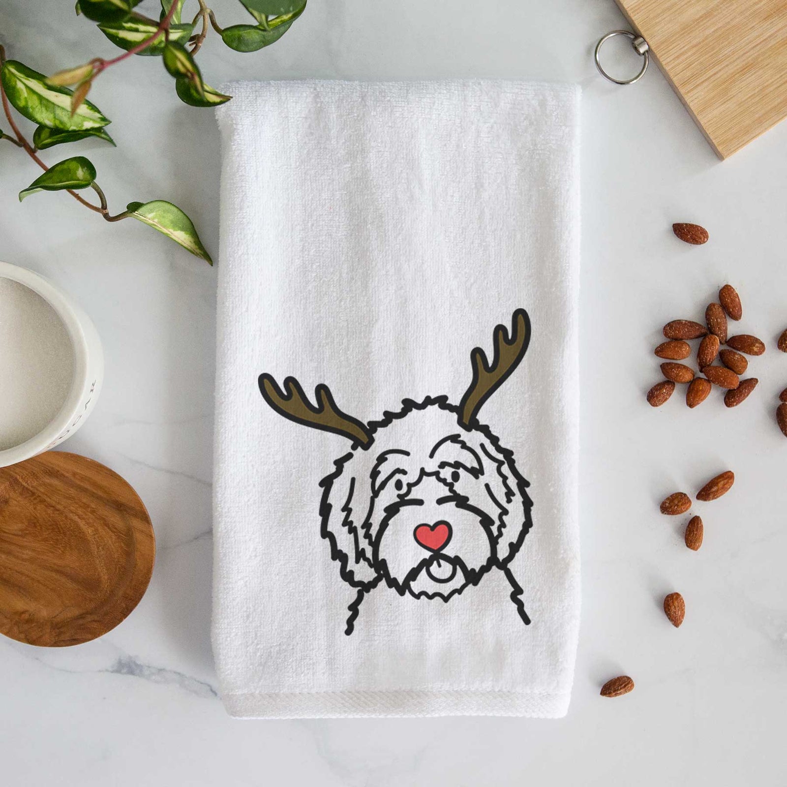 Minimalist line drawing of an Aussiedoodle with reindeer antlers and a red nose on a decorative hand towel
