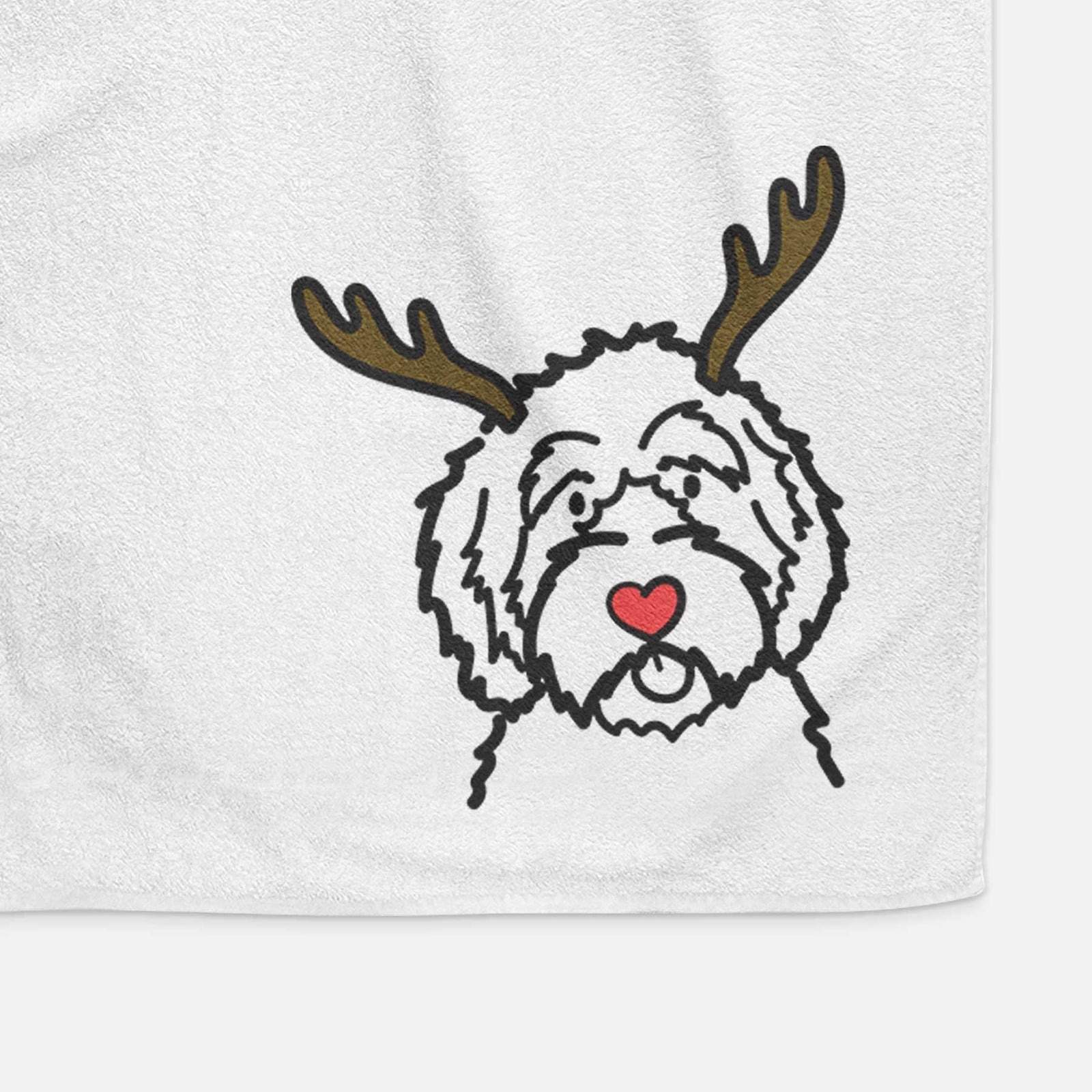 Minimalist line drawing of an Aussiedoodle with reindeer antlers and a red nose on a decorative hand towel