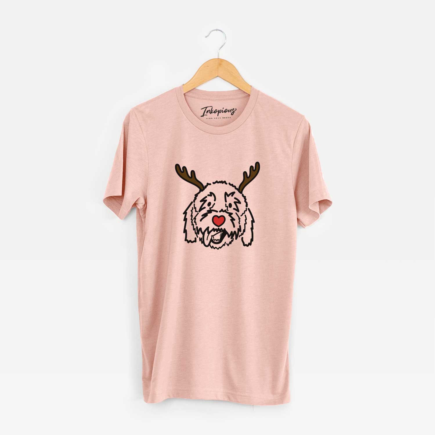Minimalist line drawing of Barry the Goldendoodle with reindeer antlers and a red nose on a Peach Unisex crewneck