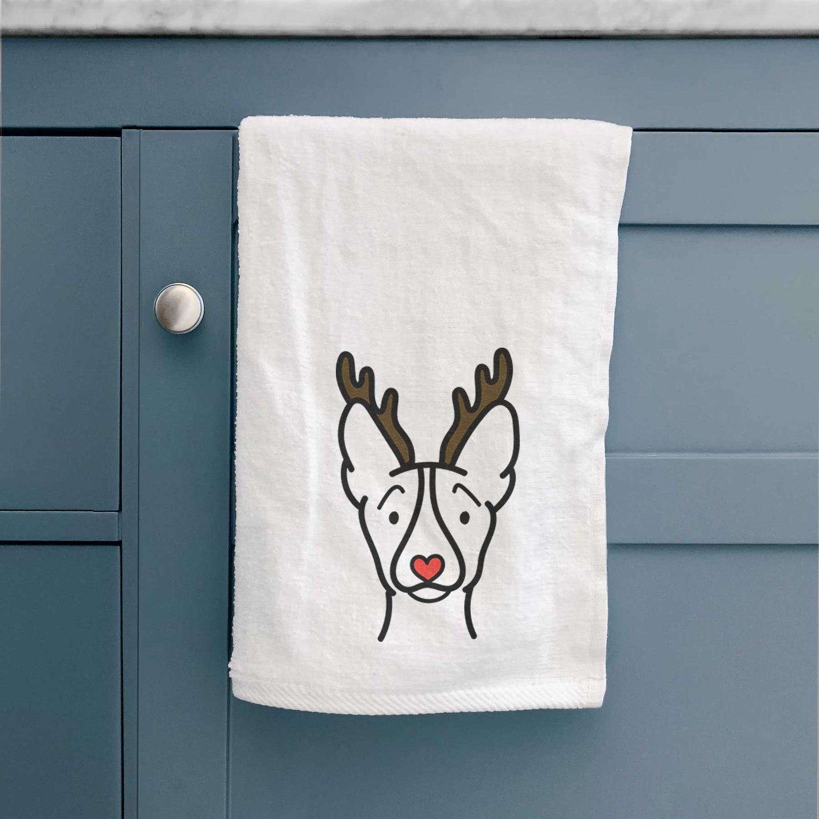 Minimalist line drawing of a Basenji with reindeer antlers and a red nose on a decorative hand towel