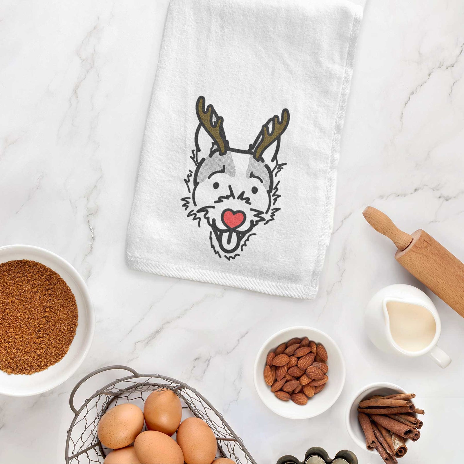 Minimalist line drawing of Baxter the Jack Russell Terrier with reindeer antlers and a red nose on a decorative hand towel