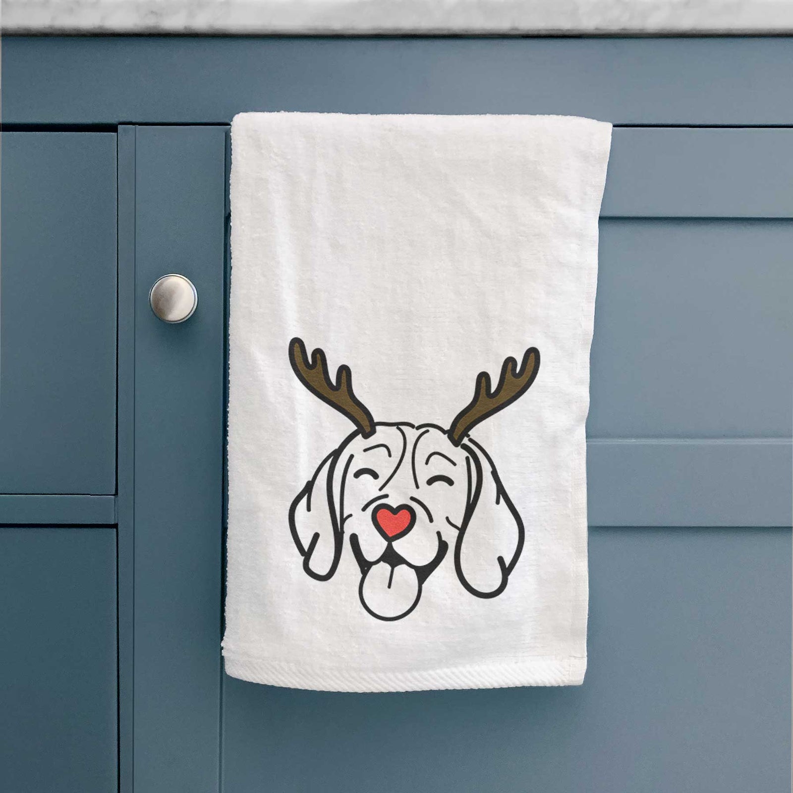 Minimalist line drawing of a Beagle with reindeer antlers and a red nose on a decorative hand towel