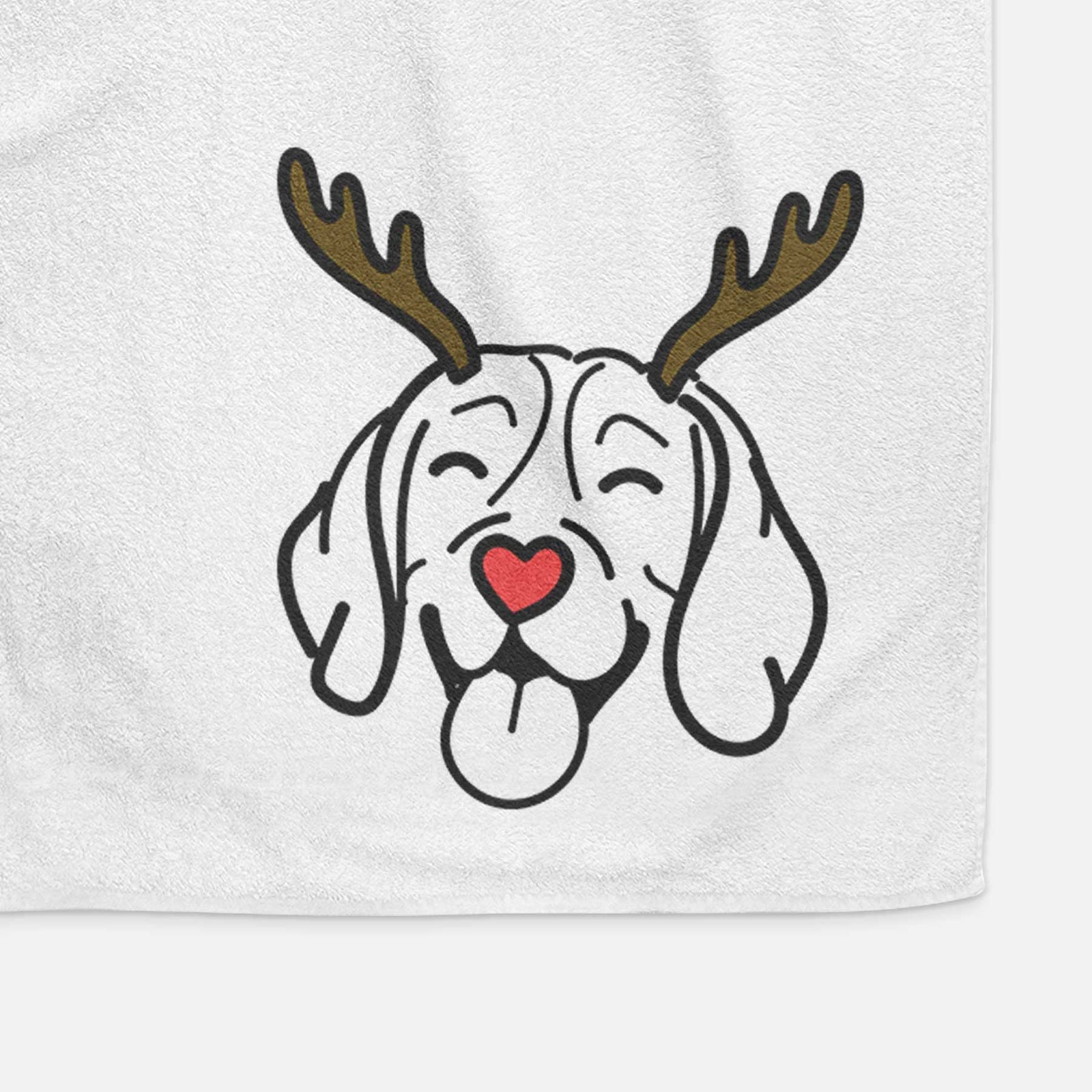 Minimalist line drawing of a Beagle with reindeer antlers and a red nose on a decorative hand towel