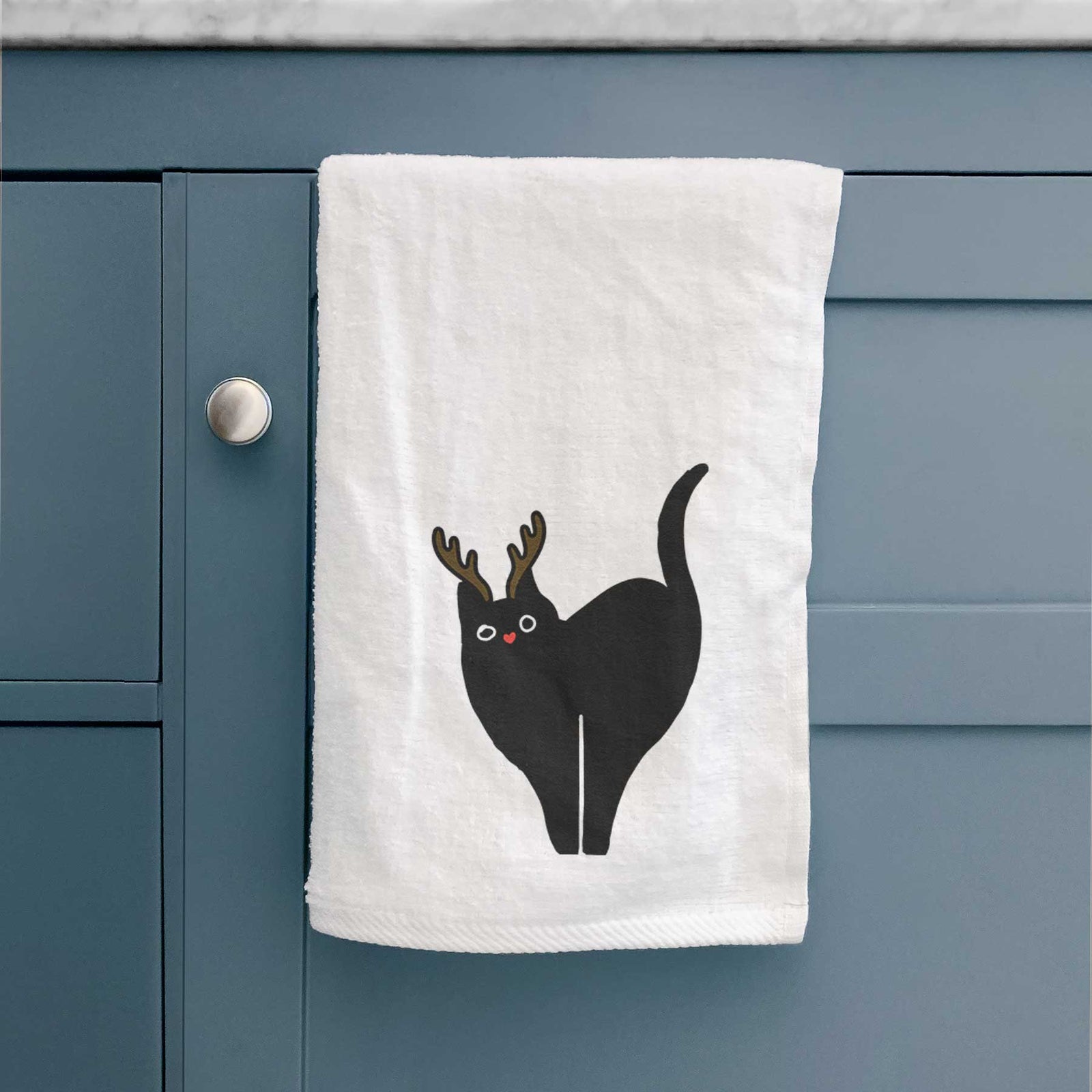 Minimalist line drawing of Bella the Black Cat with reindeer antlers and a red nose on a decorative hand towel