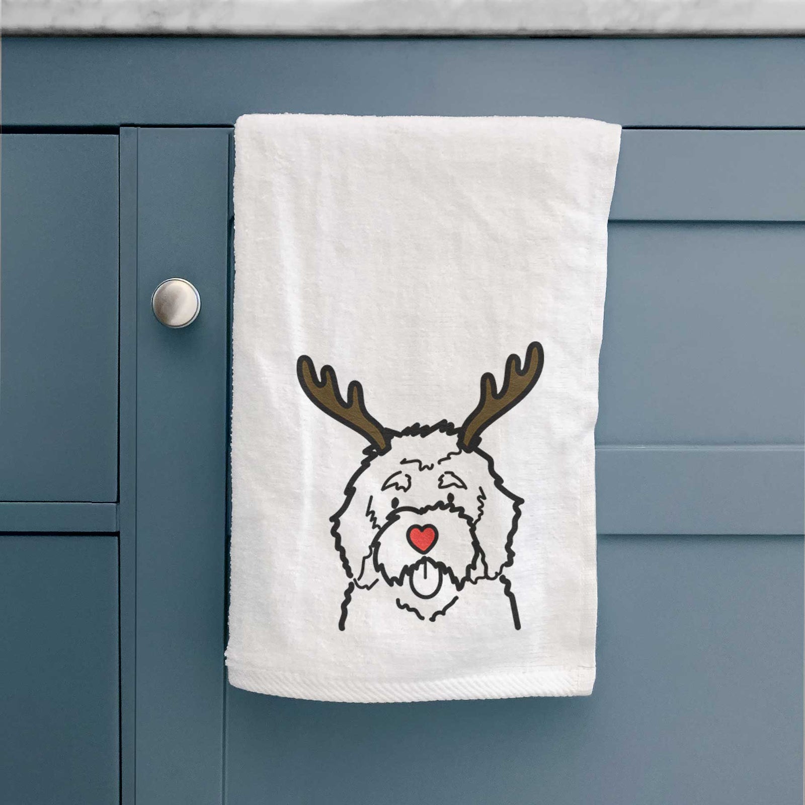 Minimalist line drawing of a Bernedoodle with reindeer antlers and a red nose on a decorative hand towel