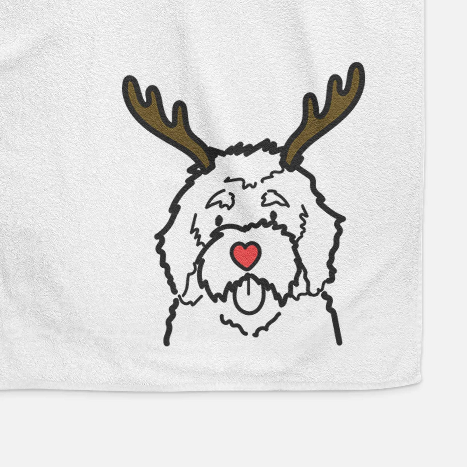 Minimalist line drawing of a Bernedoodle with reindeer antlers and a red nose on a decorative hand towel