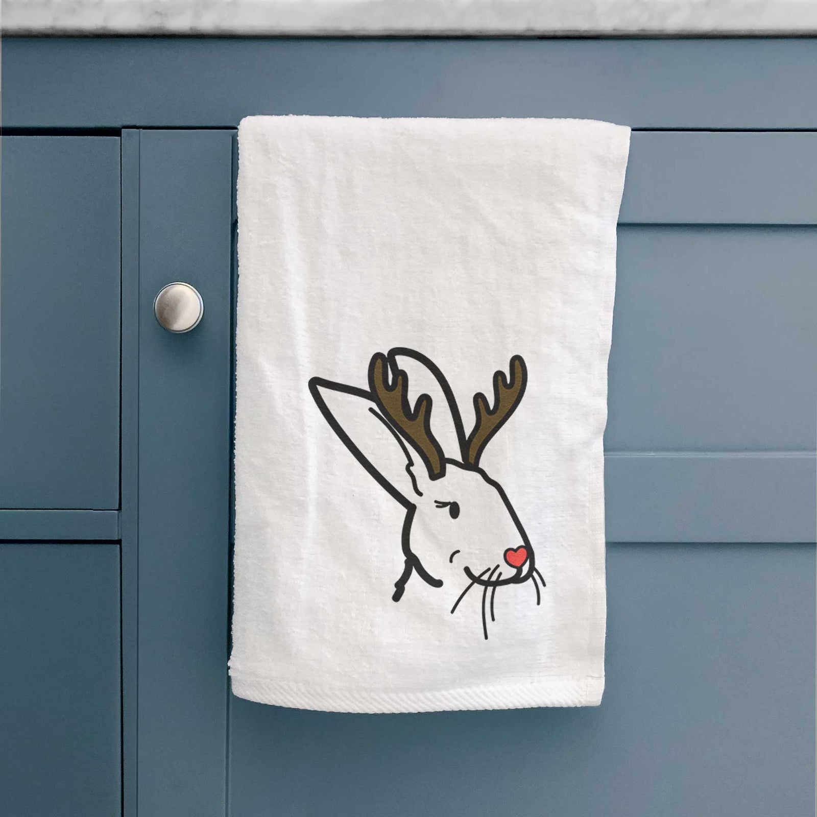Minimalist line drawing of Betsy the Rex Rabbit with reindeer antlers and a red nose on a decorative hand towel