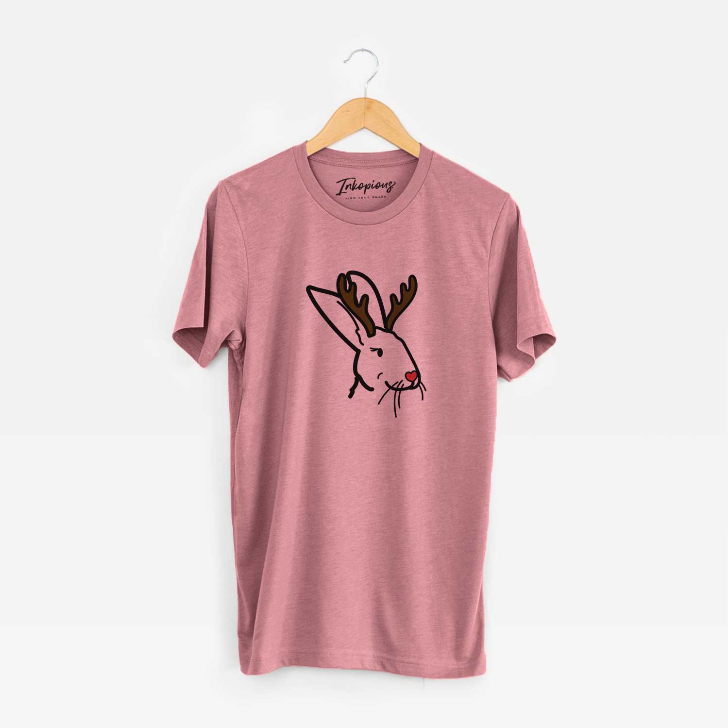 Minimalist line drawing of Betsy the Rex Rabbit with reindeer antlers and a red nose on a Mauve Unisex crewneck