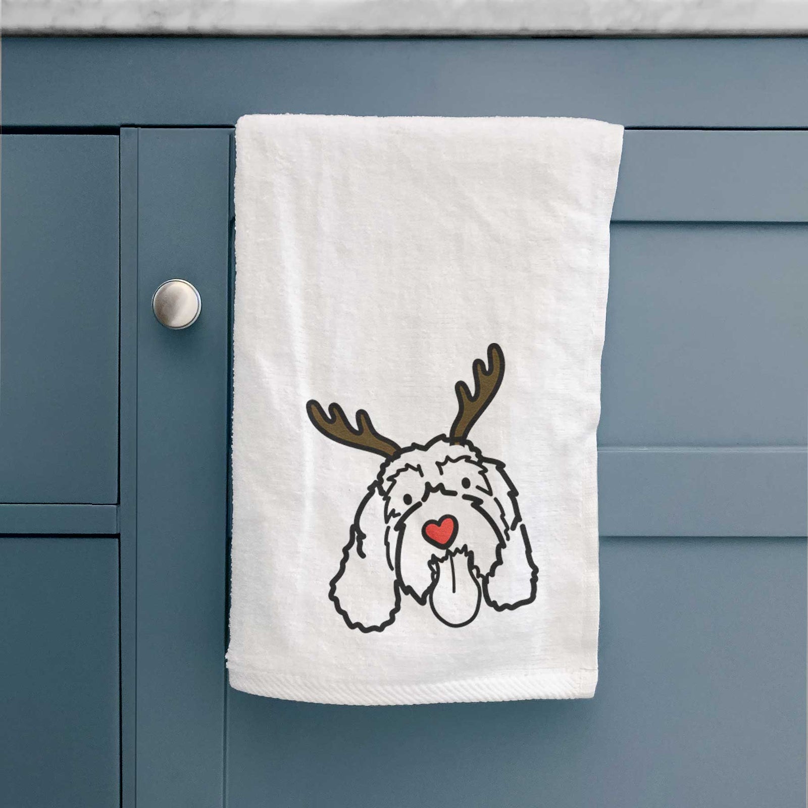 Minimalist line drawing of Bo the Portguese Water Dog with reindeer antlers and a red nose on a decorative hand towel
