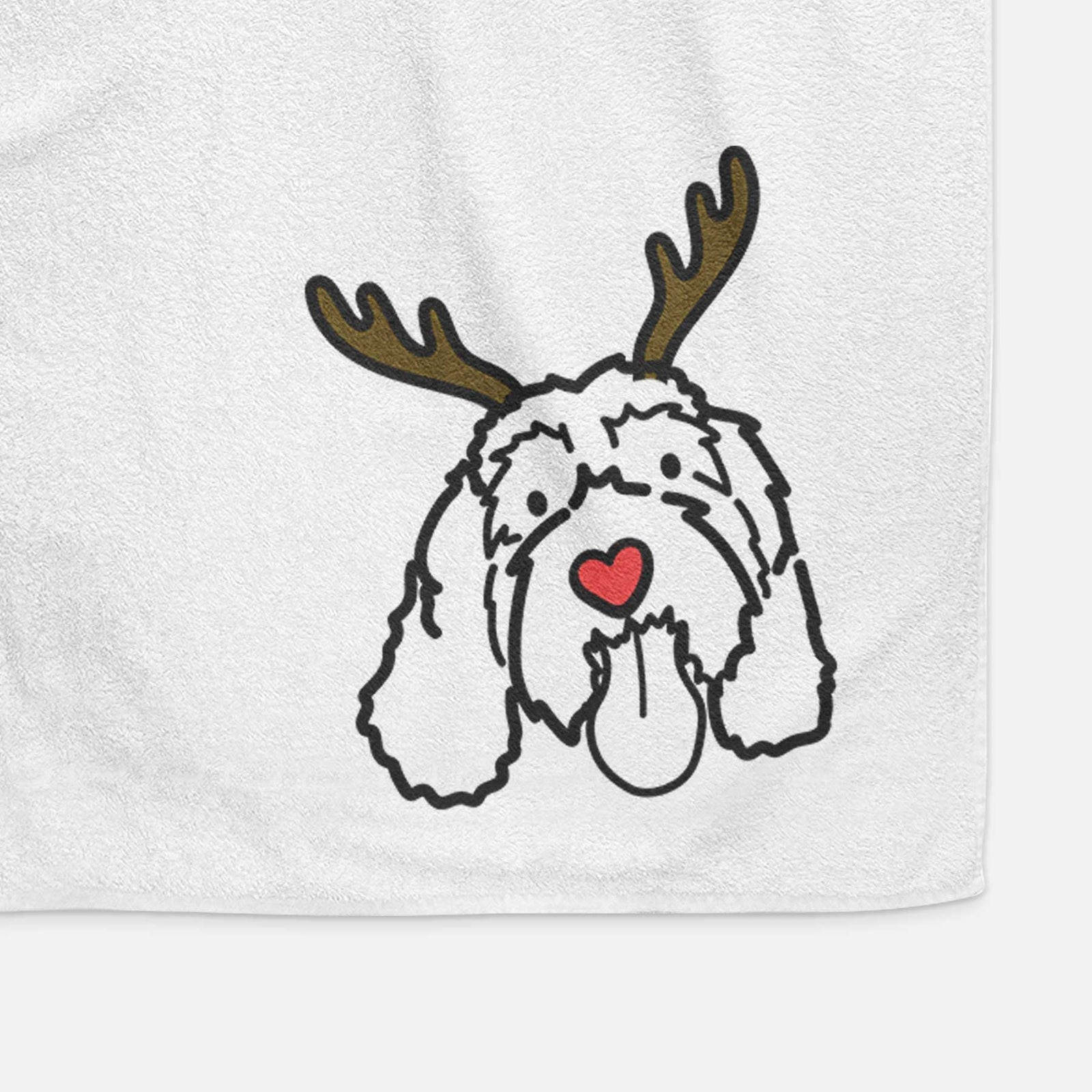 Minimalist line drawing of Bo the Portguese Water Dog with reindeer antlers and a red nose on a decorative hand towel