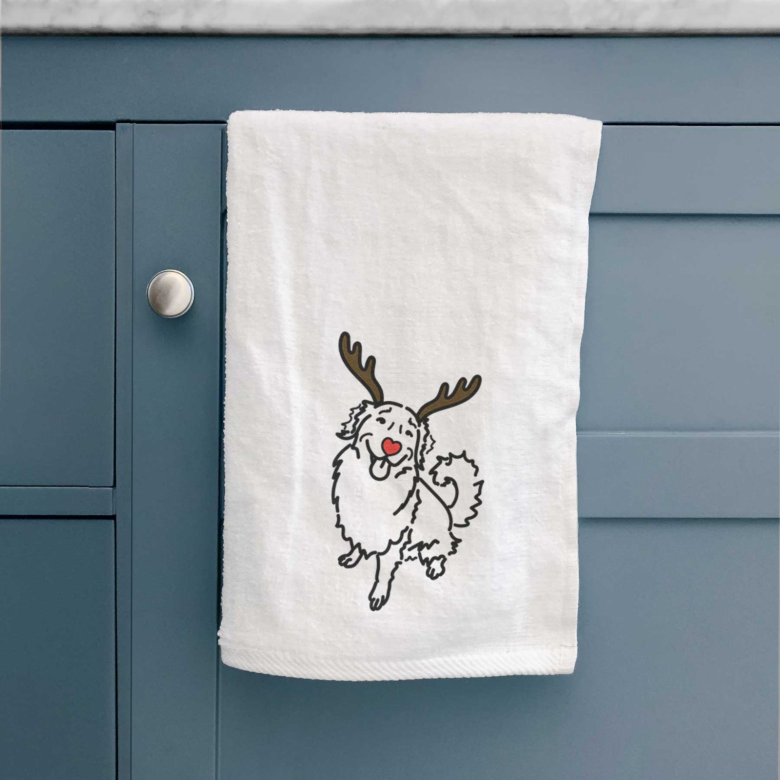 Minimalist line drawing of Brinkley the Golden Retriever with reindeer antlers and a red nose on a decorative hand towel