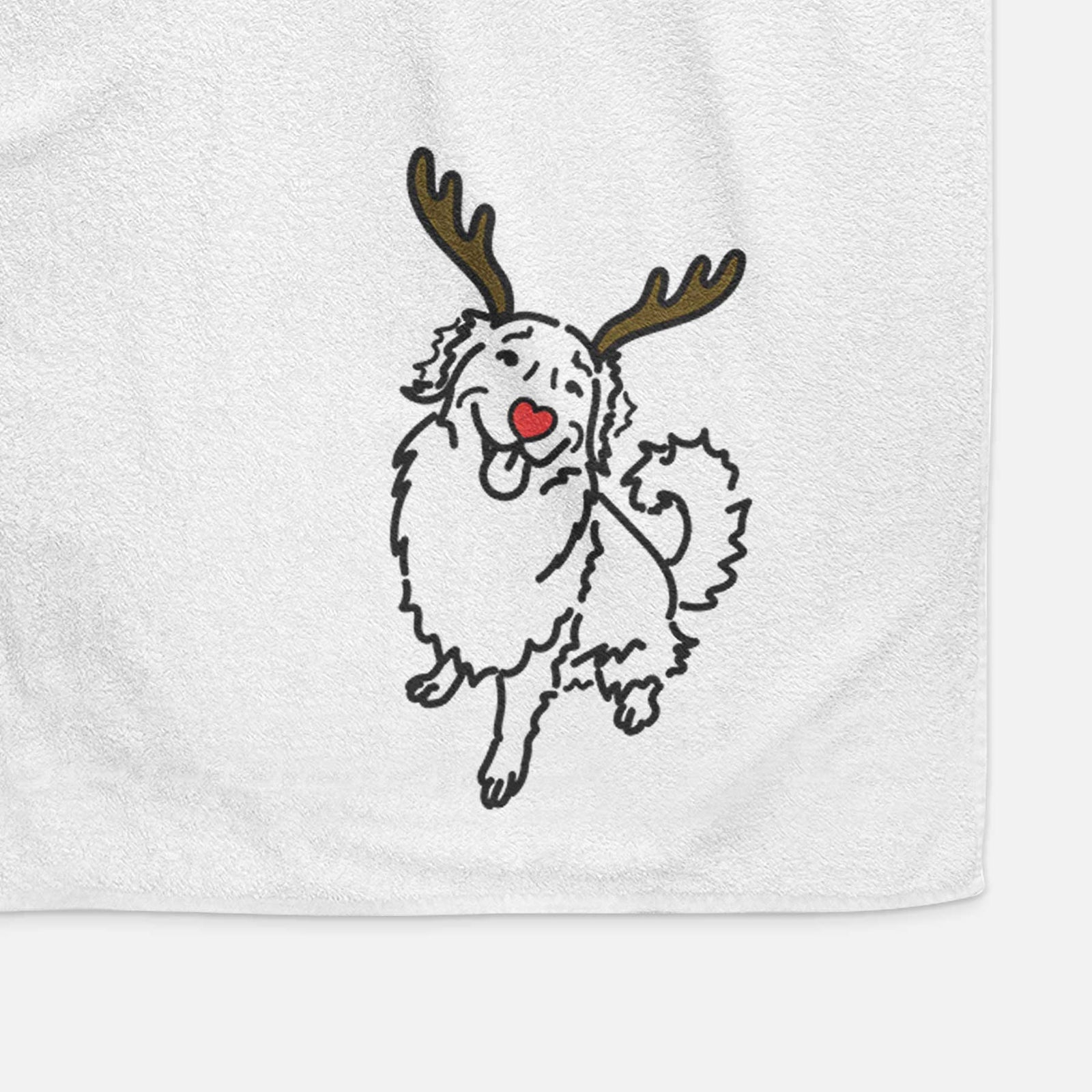 Minimalist line drawing of Brinkley the Golden Retriever with reindeer antlers and a red nose on a decorative hand towel