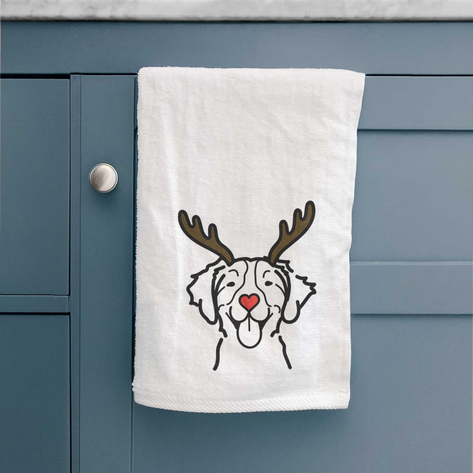 Minimalist line drawing of a Brittany with reindeer antlers and a red nose on a decorative hand towel