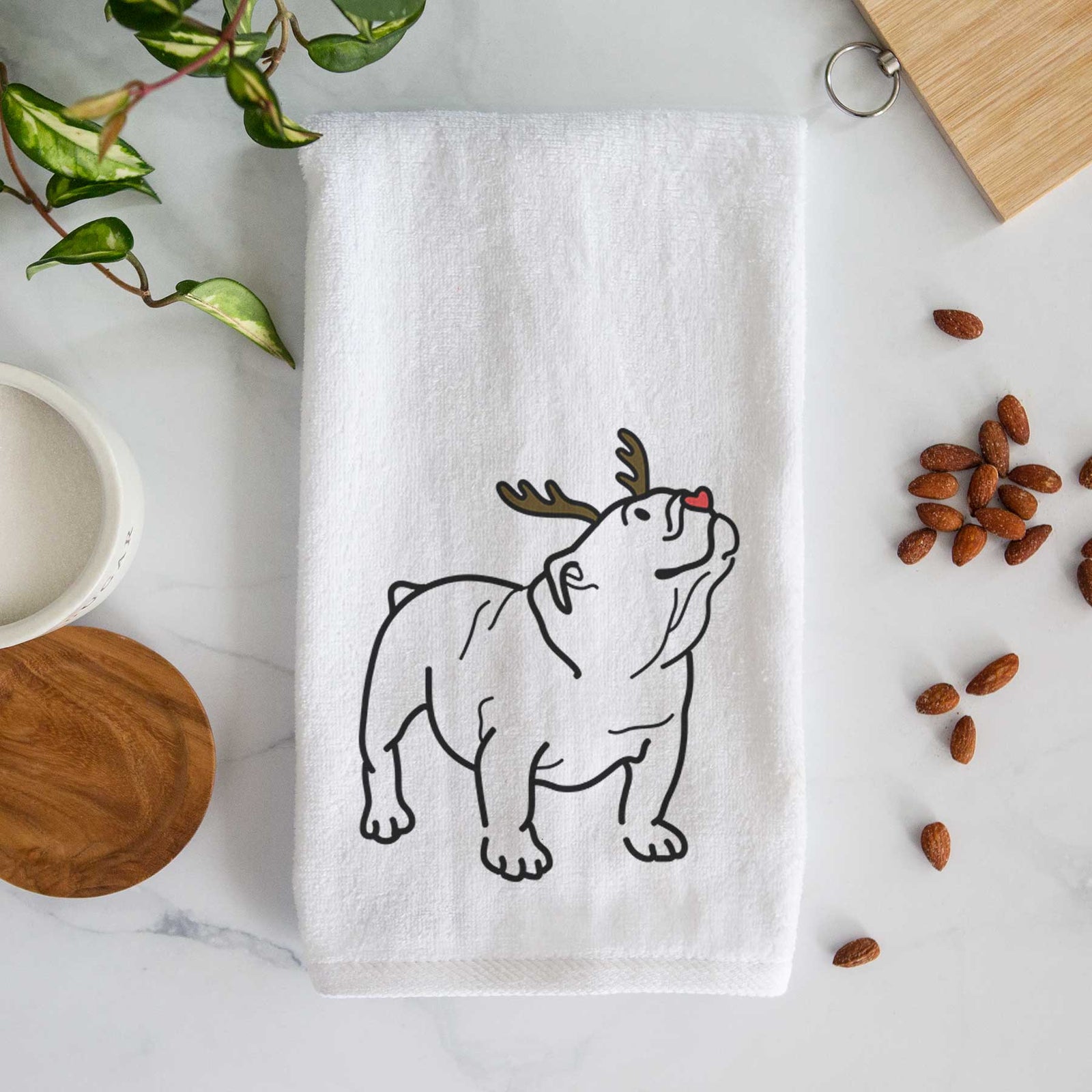 Minimalist line drawing of Bruno the English Bulldog with reindeer antlers and a red nose on a decorative hand towel