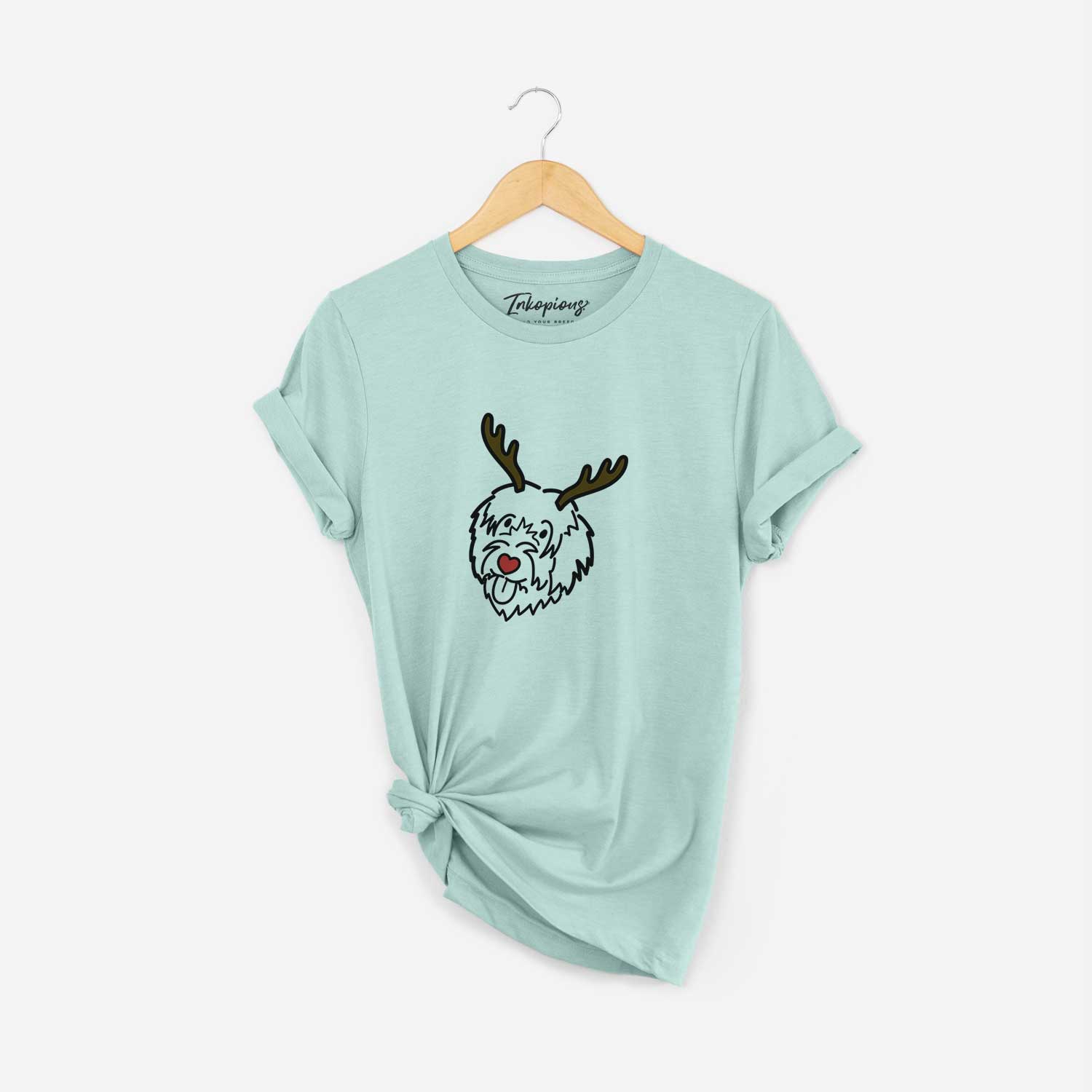 Minimalist line drawing of a Catalan Sheepdog with reindeer antlers and a red nose on a Heather Sage Unisex crewneck