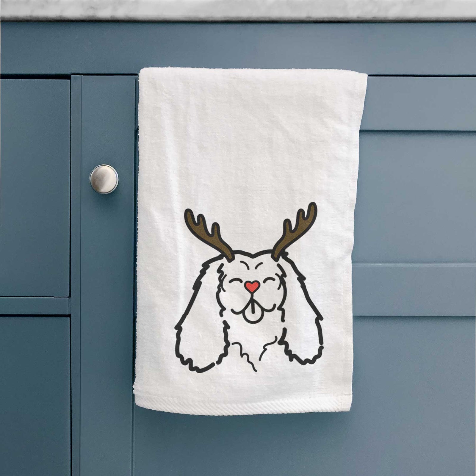 Minimalist line drawing of a Cavalier King Charles Spaniel with reindeer antlers and a red nose on a decorative hand towel