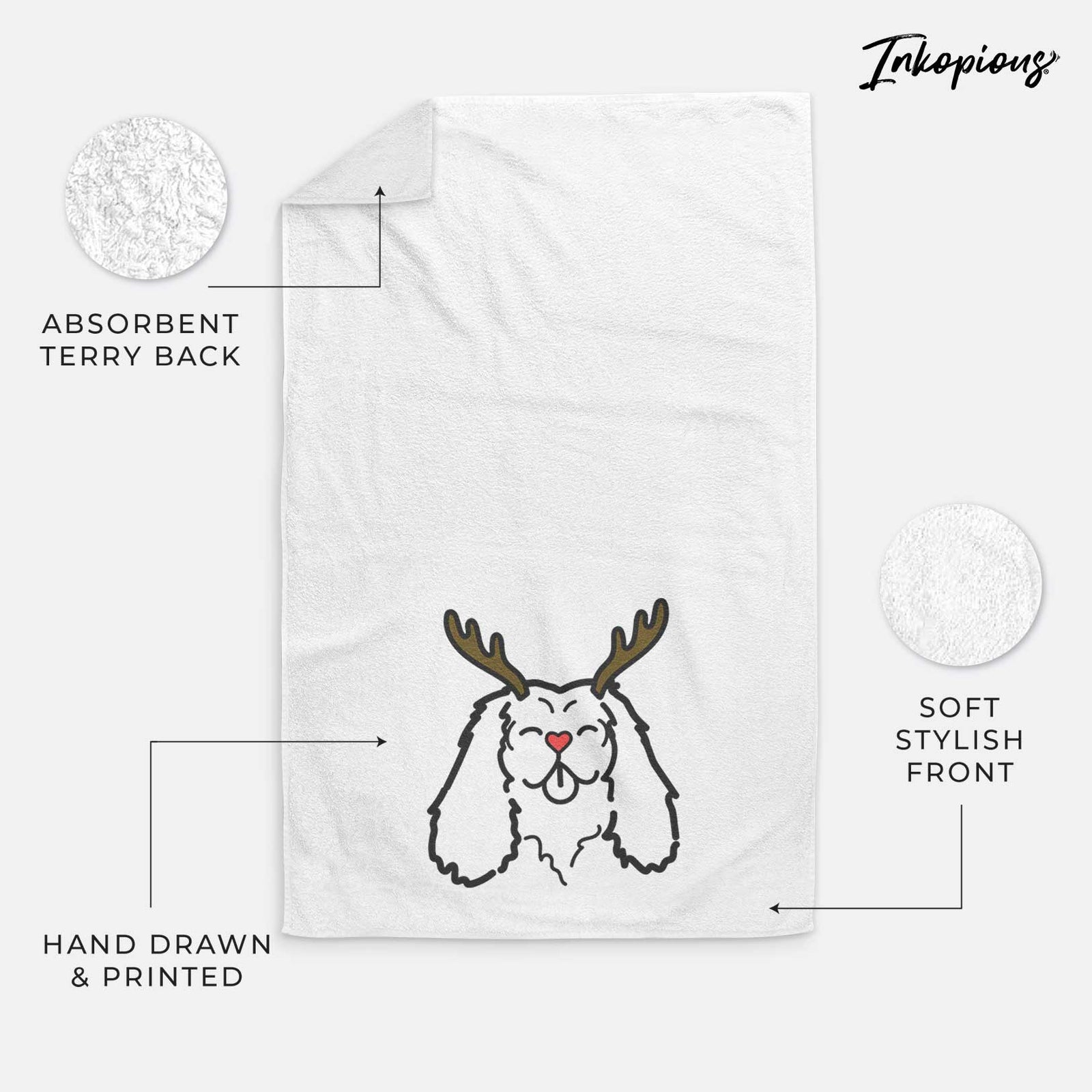 Minimalist line drawing of a Cavalier King Charles Spaniel with reindeer antlers and a red nose on a decorative hand towel