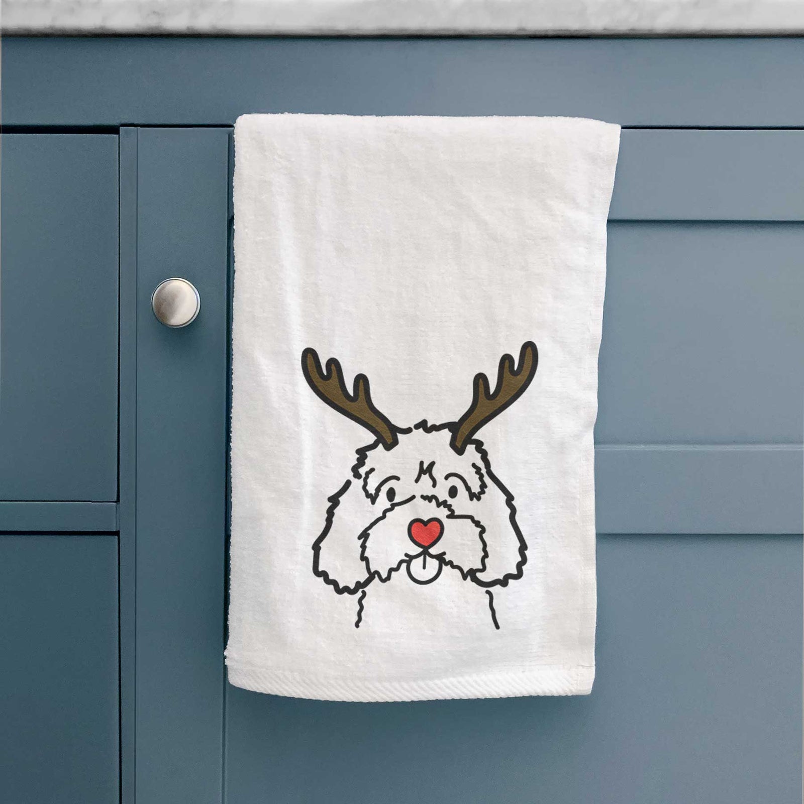 Minimalist line drawing of a Cavapoo with reindeer antlers and a red nose on a decorative hand towel
