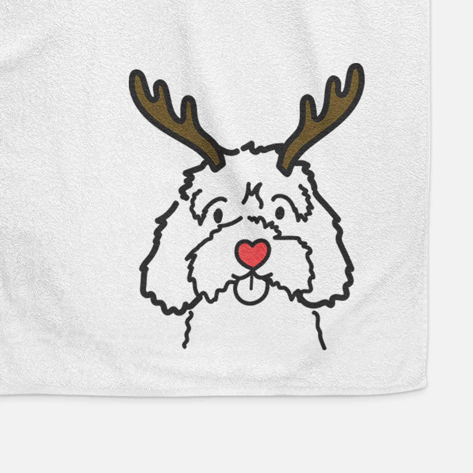 Minimalist line drawing of a Cavapoo with reindeer antlers and a red nose on a decorative hand towel