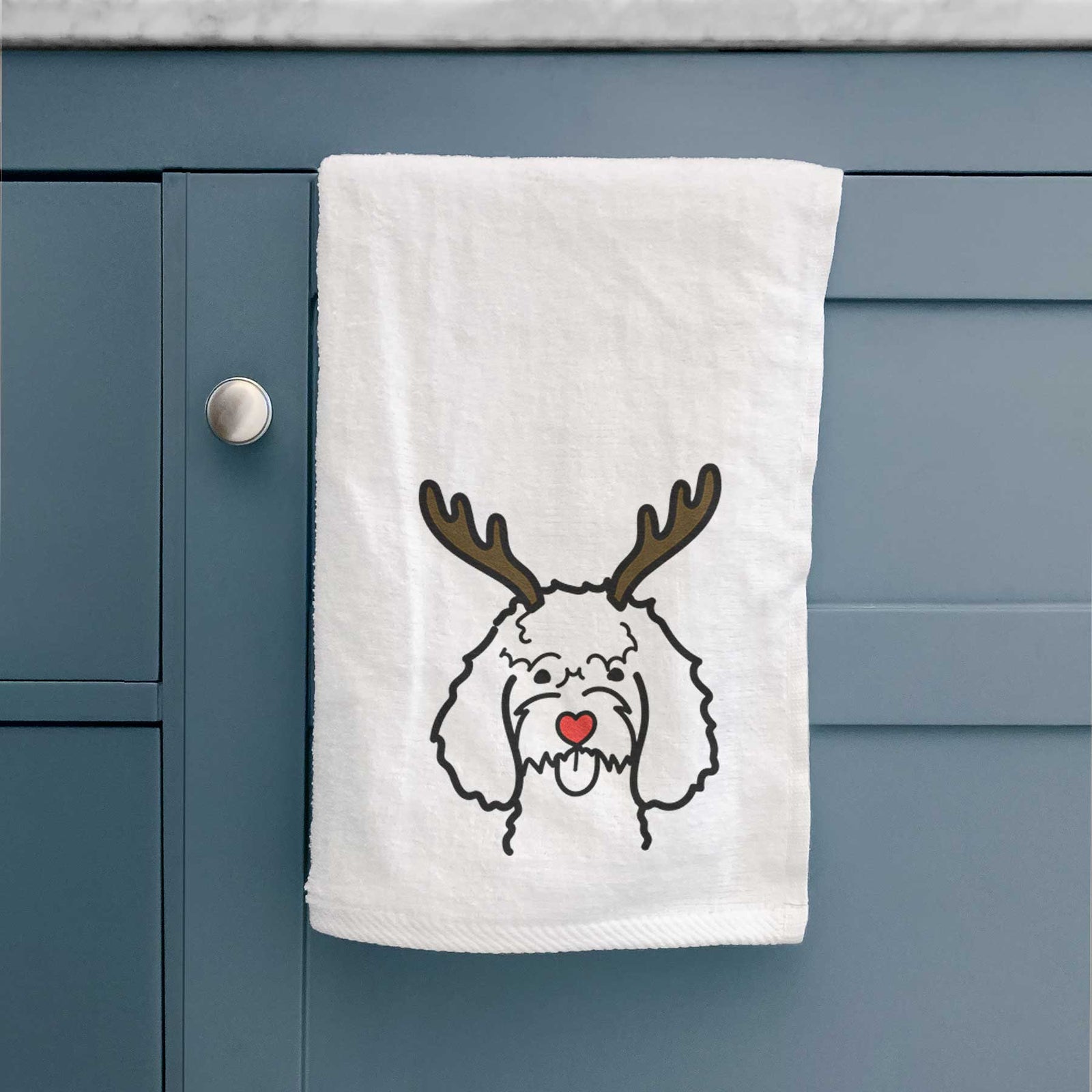 Minimalist line drawing of a Cockapoo with reindeer antlers and a red nose on a decorative hand towel