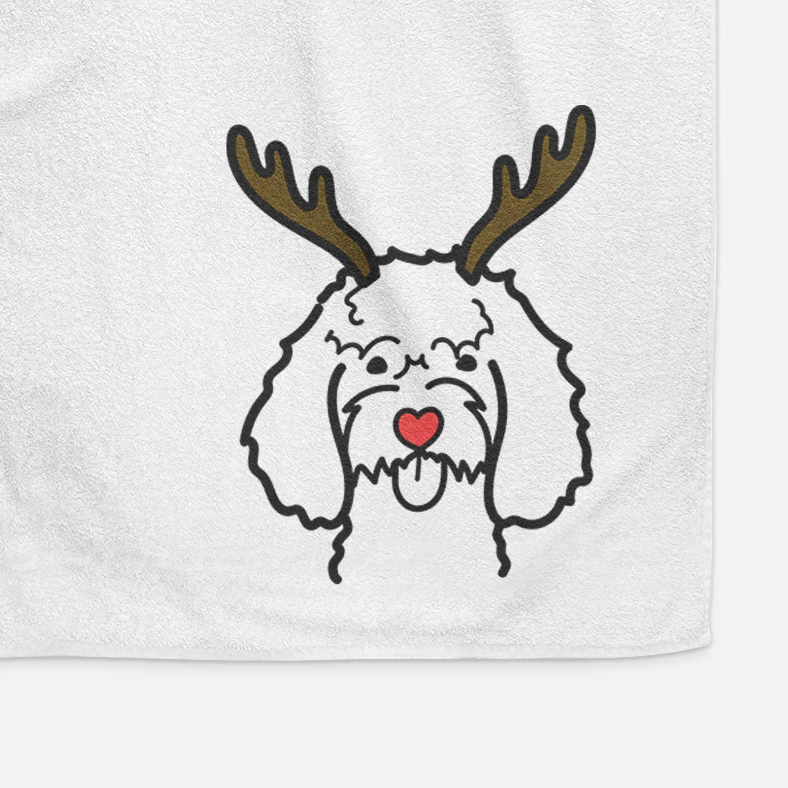 Minimalist line drawing of a Cockapoo with reindeer antlers and a red nose on a decorative hand towel