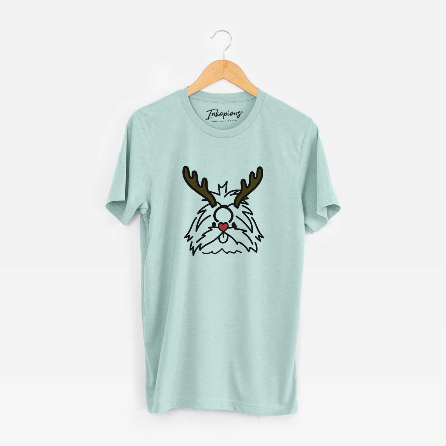 Minimalist line drawing of CoCo the Shih Tzu with reindeer antlers and a red nose on a Heather Sage Unisex crewneck