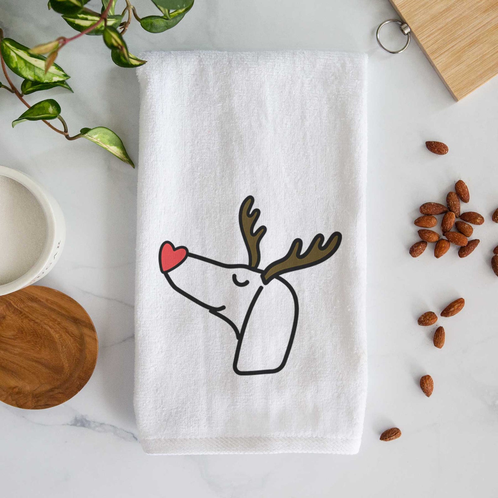 Minimalist line drawing of a Dachshund with reindeer antlers and a red nose on a decorative hand towel