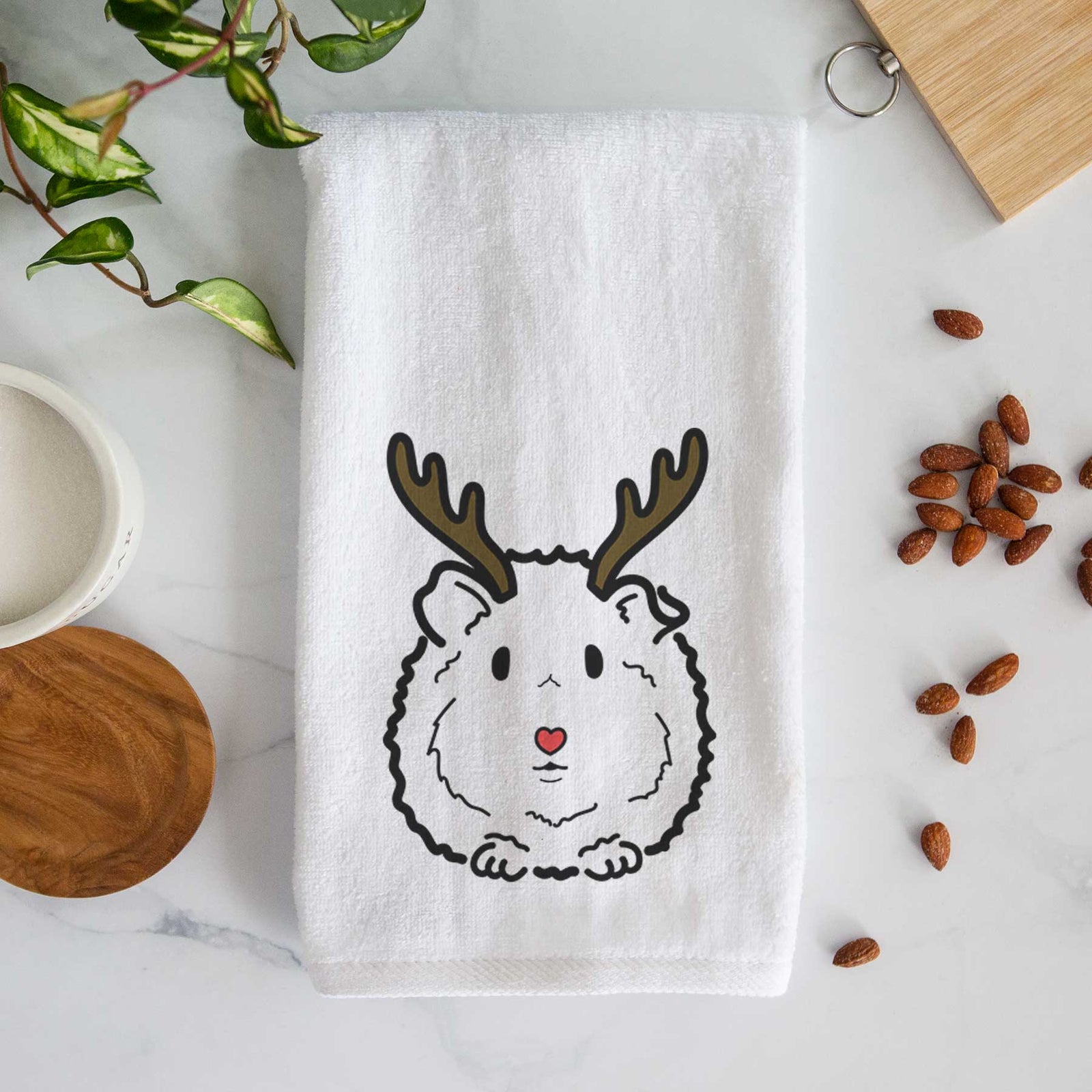 Minimalist line drawing of Duke the Guinea Pig with reindeer antlers and a red nose on a decorative hand towel